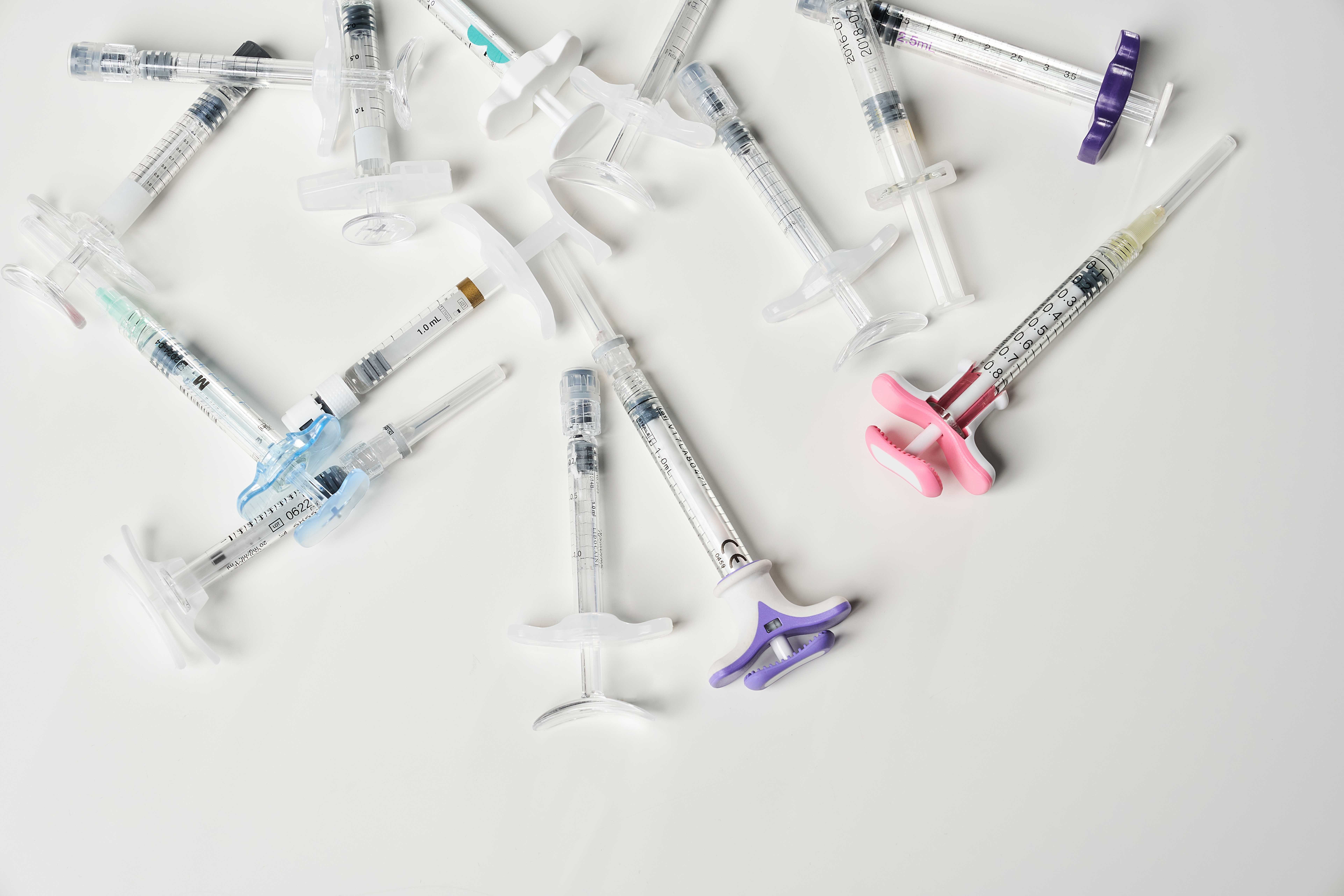 syringes-filled-with-liquid-inside-white-background-view-from-multiple-hypodermic.jpg